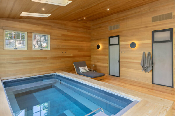 Bath house pool with doors accessing steam room and sauna