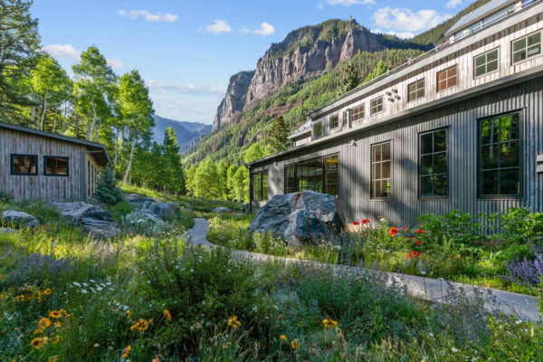Path from mudroom to bathhouse with rock and flower gardens
